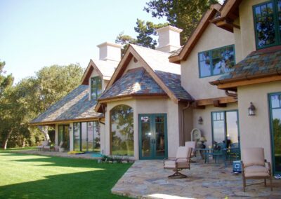 A large house with a patio and lawn.
